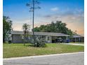 Charming single story home boasts a well-maintained lawn, mature landscaping and a covered carport at 6208 Florida E Cir, Apollo Beach, FL 33572