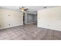 Bright living room featuring tiled floors, a ceiling fan, and neutral-toned walls at 6208 Florida E Cir, Apollo Beach, FL 33572