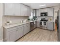 Modern kitchen with gray cabinetry, stainless steel appliances, granite countertops and tile backsplash at 6235 17Th N Ave, St Petersburg, FL 33710