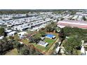 Aerial view of a property with mature trees, situated in a community setting with a clear property outline in red at 6673 146Th N Ave, Clearwater, FL 33764