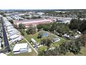 Aerial view of a spacious property with mature trees, a storage facility nearby, and easy access to the highway at 6673 146Th N Ave, Clearwater, FL 33764
