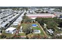 Aerial view of a spacious lot outlined in red, featuring mature trees and access to both community living and commercial convenience at 6673 146Th N Ave, Clearwater, FL 33764