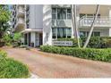 Well-maintained exterior of Harbour Hill with palm trees and updated landscaping at 700 Beach Ne Dr # 704, St Petersburg, FL 33701