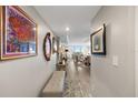 Bright hallway featuring bench seating, art, and tile floors leading to the dining area at 700 Beach Ne Dr # 704, St Petersburg, FL 33701