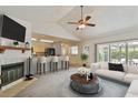 Bright living room featuring fireplace, bar seating, and sliding glass doors at 7035 Drury St, Tampa, FL 33635