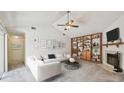 Spacious living room featuring vaulted ceilings, a fireplace, and custom built-ins at 7035 Drury St, Tampa, FL 33635