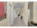 Inviting hallway with neutral walls, tile flooring, and a view of the home's living spaces beyond at 8562 Acorn Ridge Ct, Tampa, FL 33625