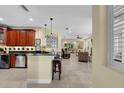 Inviting living space with a kitchen island, comfortable seating, and natural light from the windows at 8562 Acorn Ridge Ct, Tampa, FL 33625