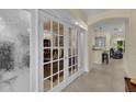 Elegant office space with glass French doors, neutral paint, and view of an open floor plan at 8562 Acorn Ridge Ct, Tampa, FL 33625