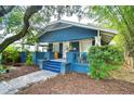 Inviting home exterior featuring a cozy front porch and a well-manicured landscape at 902 W Columbus Dr, Tampa, FL 33602