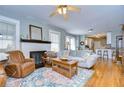 Comfortable living room with fireplace, hardwood floors, and an open floorplan to the kitchen at 902 W Columbus Dr, Tampa, FL 33602