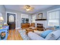 Cozy living room featuring wood floors, a classic fireplace, and plenty of natural light at 902 W Columbus Dr, Tampa, FL 33602
