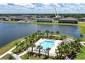 Scenic aerial view of community pool, lake and surrounding neighborhood at 937 Royal Empress Dr, Ruskin, FL 33570