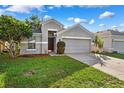 Inviting single-story home with lush green lawn and attached two-car garage under a sunny sky at 9479 Southern Charm Cir, Brooksville, FL 34613