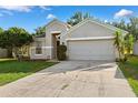 Neat single-story home boasts a well-kept lawn and features a convenient attached two-car garage at 9479 Southern Charm Cir, Brooksville, FL 34613