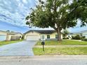 Charming single-story home featuring a well-maintained lawn and a two-car garage at 11217 Fiddlewood Dr, Riverview, FL 33579