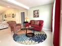 Cozy living room features tile flooring, comfortable seating, and bright light from large windows at 11217 Fiddlewood Dr, Riverview, FL 33579