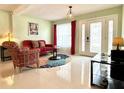 Comfortable living room boasting bright tile floors, an area rug, and direct entry to the home at 11217 Fiddlewood Dr, Riverview, FL 33579