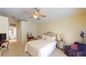 Bright bedroom with a comfortable bed, ceiling fan, and vanity area at 11368 Copley Ct, Spring Hill, FL 34609