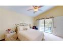 Bright bedroom with a vaulted ceiling, comfortable bed, and access to the pool area at 11368 Copley Ct, Spring Hill, FL 34609