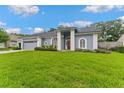 A beautiful single-story home with arched windows and a well-kept green lawn at 15615 Indian Queen Dr, Odessa, FL 33556