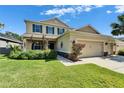 Charming two-story tan home with well-kept lawn and landscaping at 17510 Bright Wheat Dr, Lithia, FL 33547