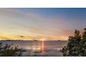 Tranquil sunset over the water creates a picturesque scene with a beautiful sky at 1963 Edgewater Dr, Clearwater, FL 33755