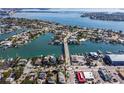 Expansive aerial view of a waterfront community with lush landscaping, a bridge, and beautiful waterways at 2100 Pass A Grille Way, St Pete Beach, FL 33706