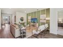 Bright living room with modern decor, a green accent wall, and comfortable seating arrangement at 2286 Sienna Spruce St, Wesley Chapel, FL 33543