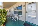 Inviting front porch with cozy seating and a view of the neighborhood at 2452 Brazilia Dr # 18, Clearwater, FL 33763