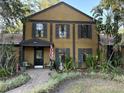 Inviting two-story home featuring a landscaped yard, brick walkway, and a charming front porch at 314 Bloomingfield Dr, Brandon, FL 33511