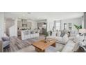 Open-concept living space features stylish decor, a kitchen island with seating, and plenty of natural light at 32702 Winterwood Blvd, Wesley Chapel, FL 33543