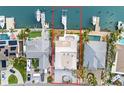 Aerial view showcases the waterfront property's private dock, backyard pool, and proximity to the bay at 5 Marina Ter, Treasure Island, FL 33706