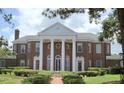 Stately brick home showcasing prominent white columns and well-manicured landscaping at 5002 S Shore Crest Cir, Tampa, FL 33609