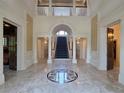 Spacious foyer with marble flooring, staircase to upper level, and arched doorway at 5002 S Shore Crest Cir, Tampa, FL 33609