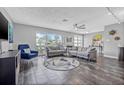 Bright living room featuring tile floors, two sofas, and large windows for ample natural light at 5080 43Rd S St, St Petersburg, FL 33711
