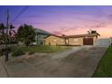 Single-story home featuring a well-maintained lawn and convenient driveway access at 5108 Commonwealth Rd, Palmetto, FL 34221