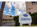 Sign for Georgetown condo association under a blue sky with clouds at 5623 80Th N St # 504, St Petersburg, FL 33709