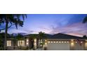 Lovely single-story home featuring a three-car garage, well-maintained landscaping, and exterior lighting at 6212 Nimes Ct, Lutz, FL 33558