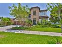 Beautiful two-story house with stone accents, lush lawn, and a spacious three-car garage at 6913 Park Strand Dr, Apollo Beach, FL 33572