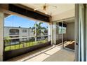 Enclosed patio with sliding glass doors, tile flooring, and a ceiling fan offers relaxing outdoor space at 7701 Starkey Rd # 504, Seminole, FL 33777