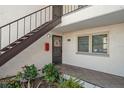 Condo exterior featuring a private entrance with stairs and well-maintained landscaping at 7701 Starkey Rd # 601, Seminole, FL 33777