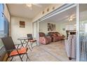 View of the sunroom and living area with slider, tile flooring, and comfortable furnishings at 7701 Starkey Rd # 601, Seminole, FL 33777