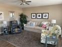 Cozy living area with a comfortable couch, accent chair, and warm decor at 8455 112Th St # 212, Seminole, FL 33772