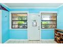 Light-filled entryway with tile floor and view to the front yard at 9802 N Oregon Ave, Tampa, FL 33612