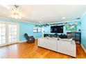 Comfortable living room featuring hardwood floors and neutral-toned decor at 9802 N Oregon Ave, Tampa, FL 33612
