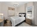 Serene bedroom enhanced by elegant curtains, sophisticated furnishings, and a contemporary aesthetic at 10447 New Brunswick St, Port Charlotte, FL 33981