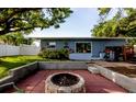 Outdoor space with a stone firepit and terraced hardscape, perfect for entertaining at 10980 104Th Ave, Largo, FL 33778