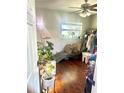 Cozy room with a window, ceiling fan, wood flooring, and plentiful plants at 10980 104Th Ave, Largo, FL 33778