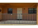 A welcoming condo entrance with sleek railings, a neutral color scheme, and clear unit number at 12900 Vonn Rd # D202, Largo, FL 33774